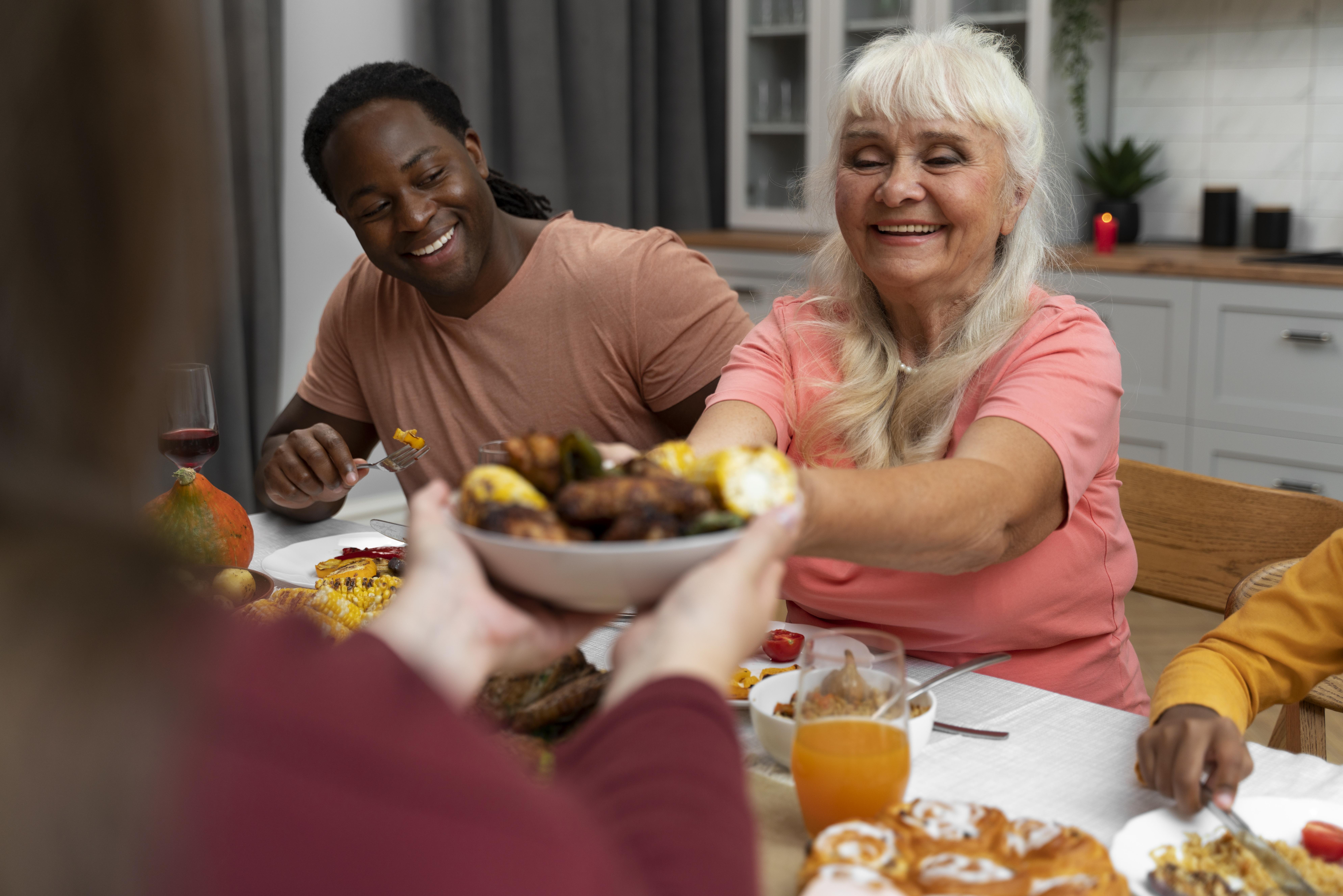 Residents enjoying a meal together at a dining table.